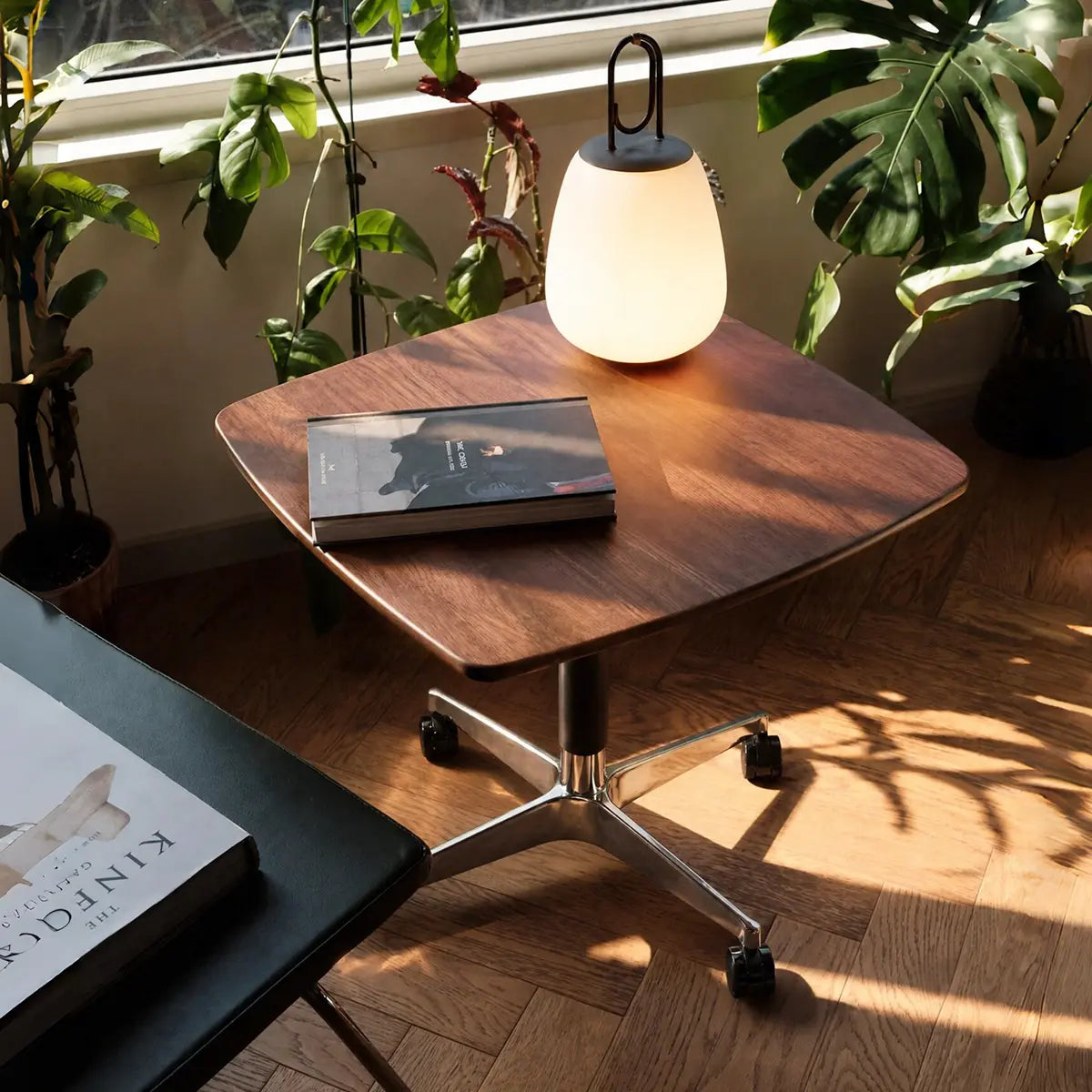 Elevora desk with a book and lamp